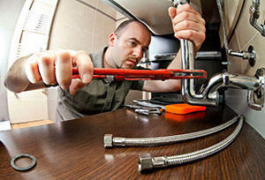 A man plumbing in a sink