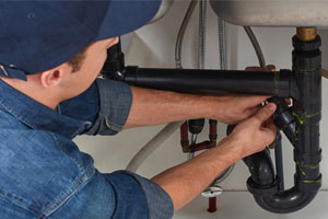 Plumber under sink - Plumber Earnings Heat Up In July