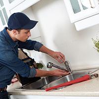 self-employed plumber fixing sink