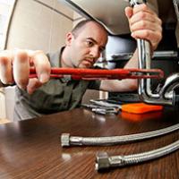A man plumbing in a sink