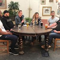 Skilled plumbing workers around a table